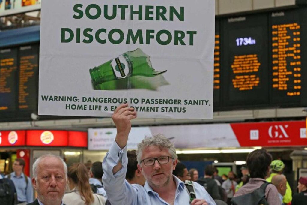 Man holds up a placard reading 'Southern Discomfort'