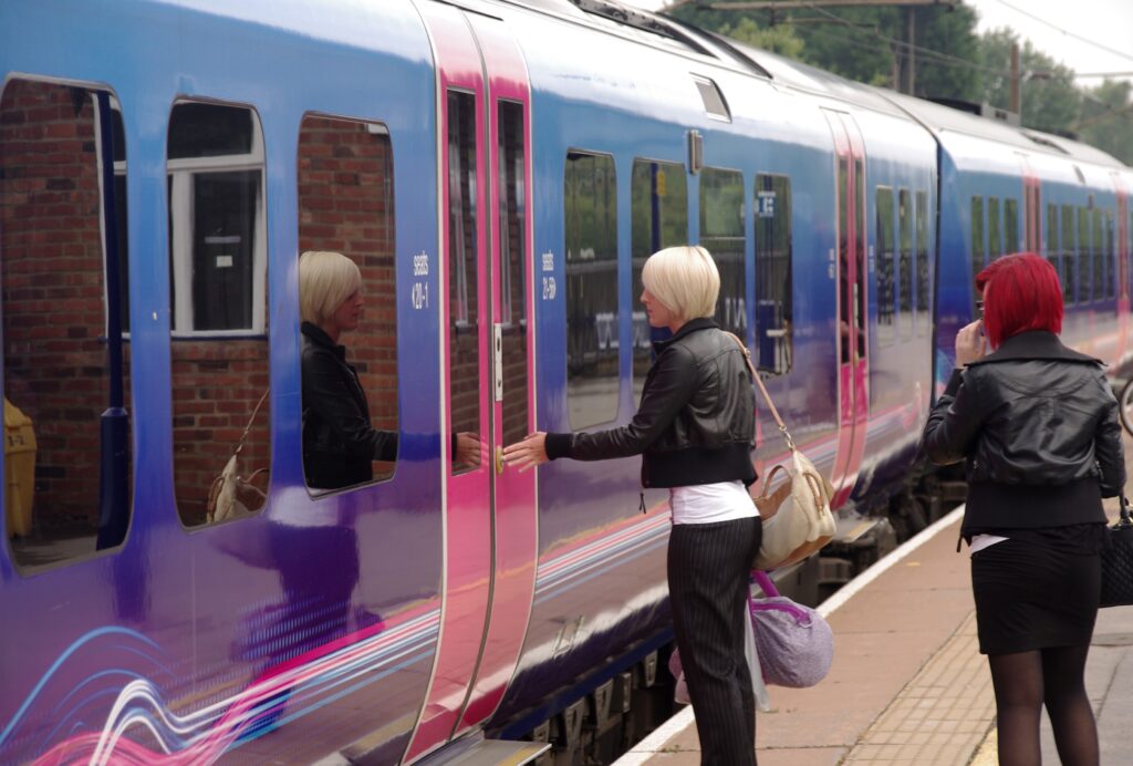 Woman in leather jacket boarding a Thameslink train