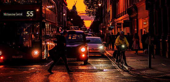 Bus, cars, cyclist and pedestrian