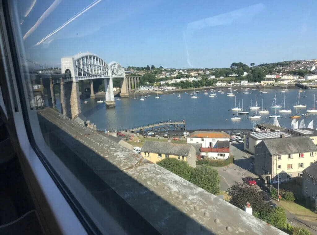 View of small sail boats and bridge over the water on a sunny day
