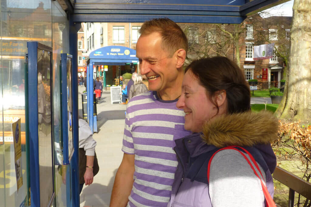 Man and woman at bus stop